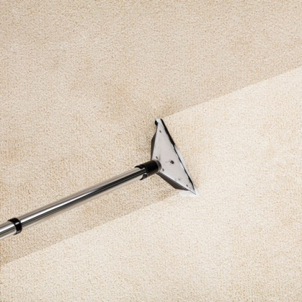 Close-up Photo Of Vacuum Cleaner With Carpet